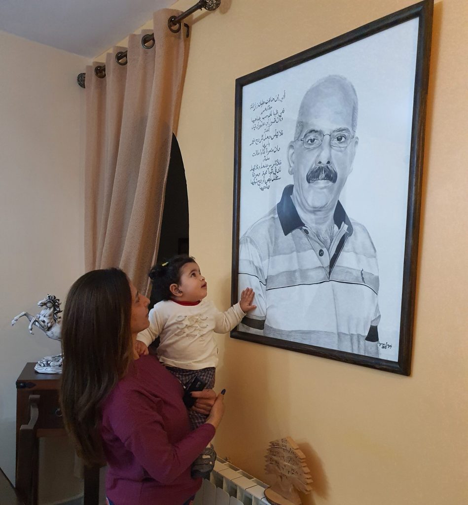 Nifrat wife, mother and grandmother looking at photo of imprisoned husband Marwan