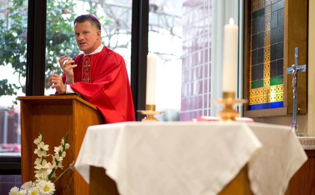 Archbishop Timothy Broglio administers communion at Travis Air Force Base on February 3, 2014. (Photo: U.S. Air Force photo/Ken Wright)